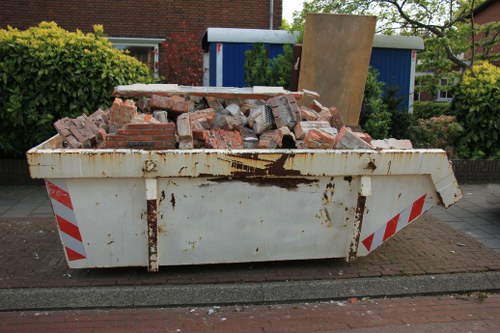 Commercial skip being loaded with construction waste in Soho