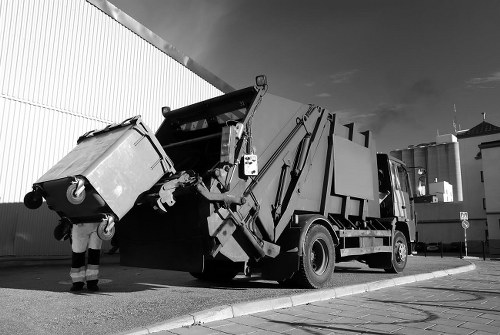Skip lorry loading at a Soho location
