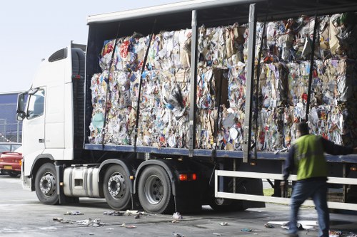 Low-carbon electric van parked by skips in Soho for eco-friendly collection