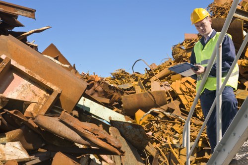 Skilled operatives and a skip on a London street demonstrating safe positioning